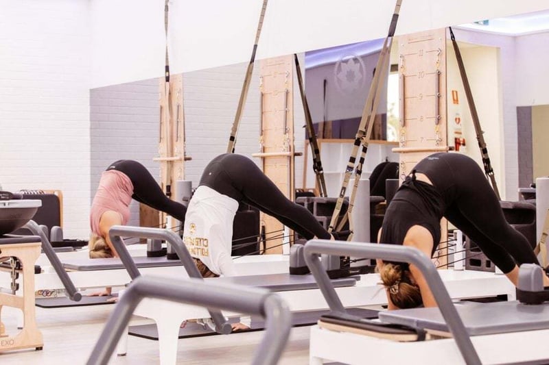 Reformer Pilates - members of Club Pilates using reformer and TRX