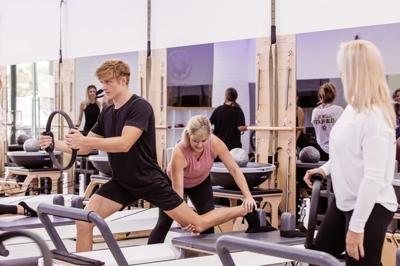 man using a Pilates ring during a session