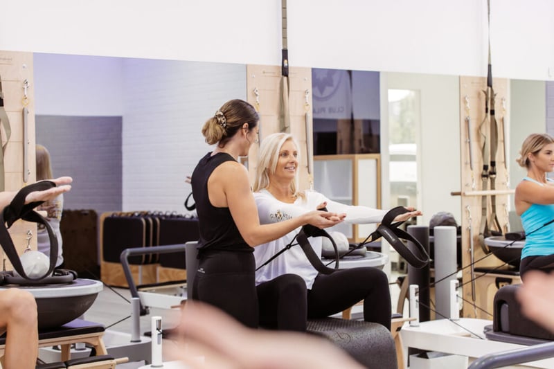 The Club Pilates Way - Instructor helping member