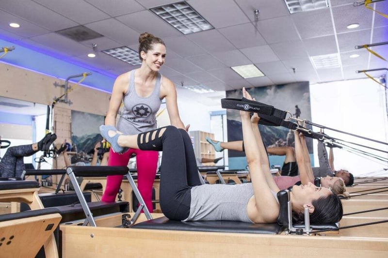 Pilates VS Yoga: Which is Best for You? - women doing Pilates on reformer