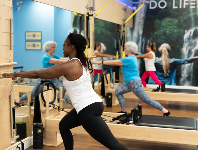 woman performing Pilates on a Pilates machine