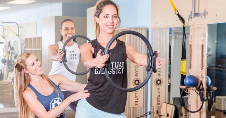 woman at Pilates demonstrating an exercise with the magic ring