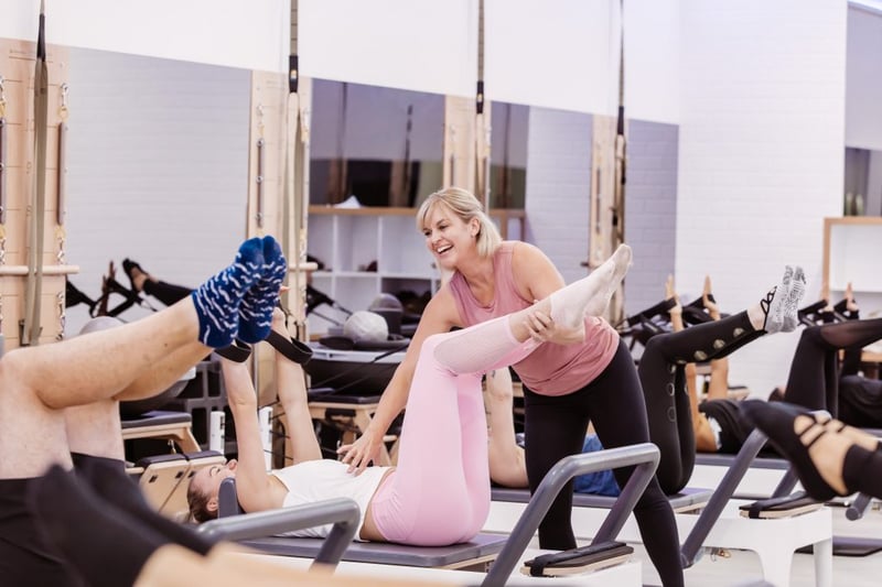 What Are Pelvic Floor Exercises? - Club Pilates instructor helping member