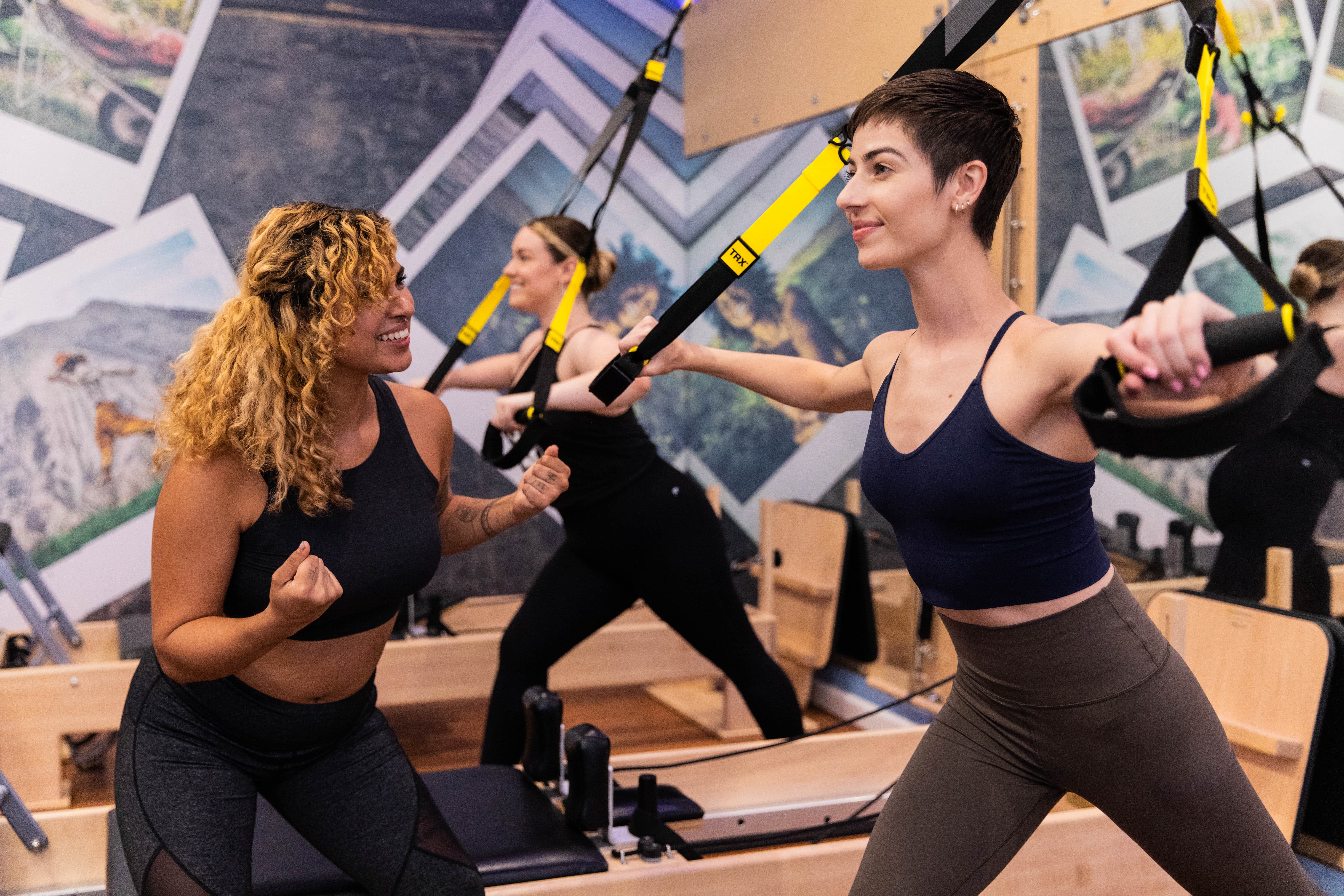 Pilates instructor encouraging participants during a session