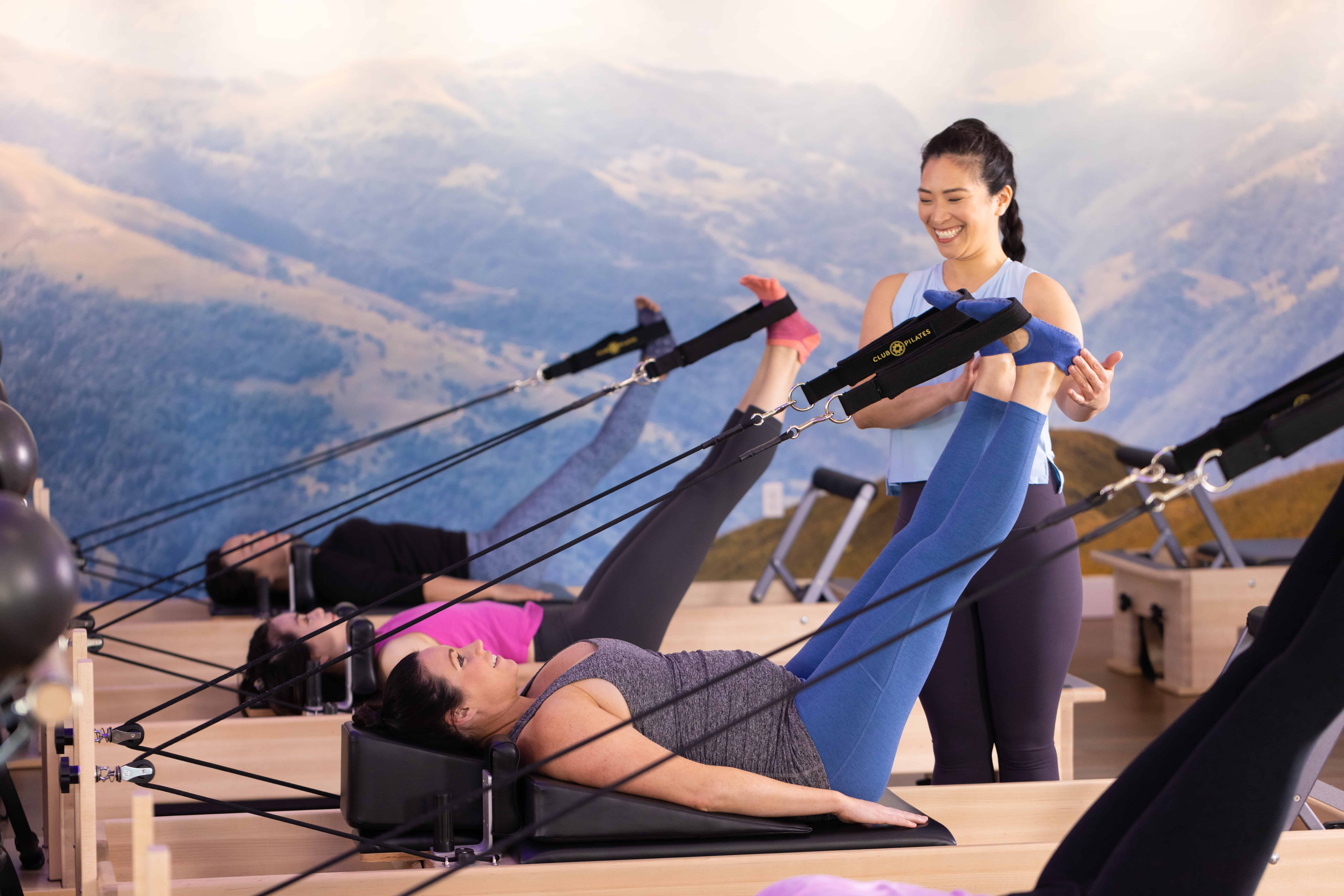 pilates class in Perth Innaloo where a student is being taught how to use foot straps